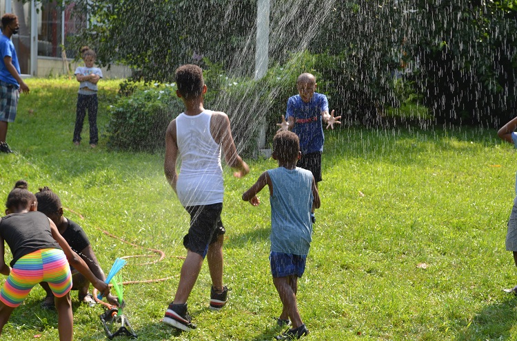 Children playing in a sprinkler.
