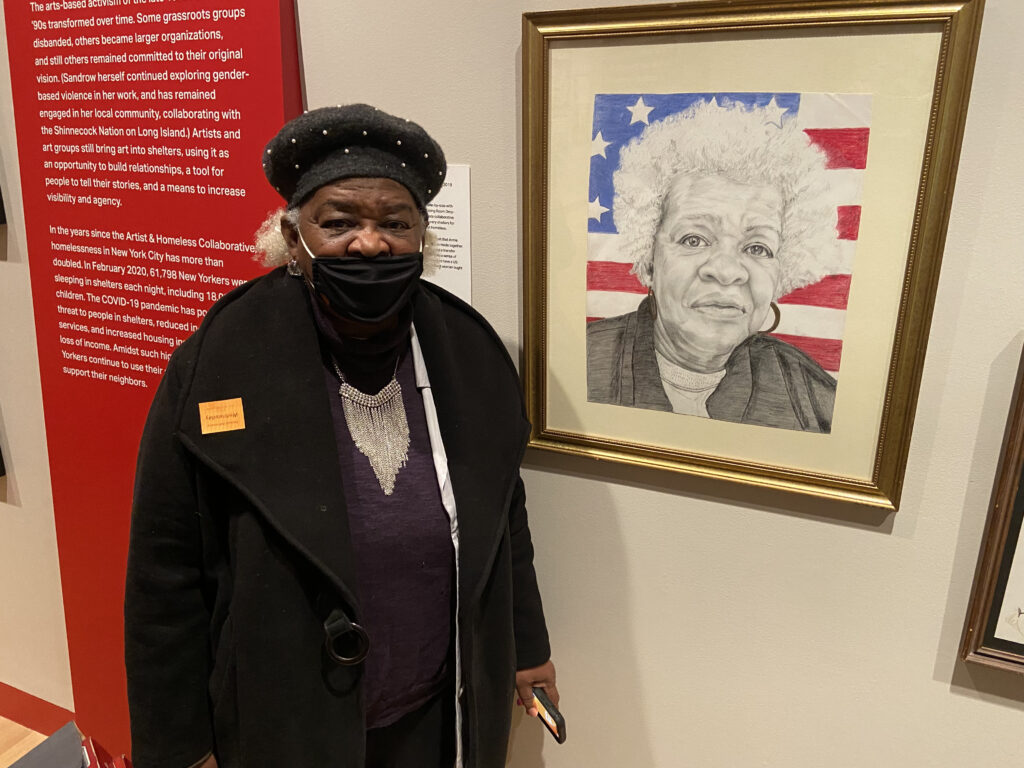 Annie W. poses with her portrait, Annie, Black Woman For President, on display at the New York Historical Society