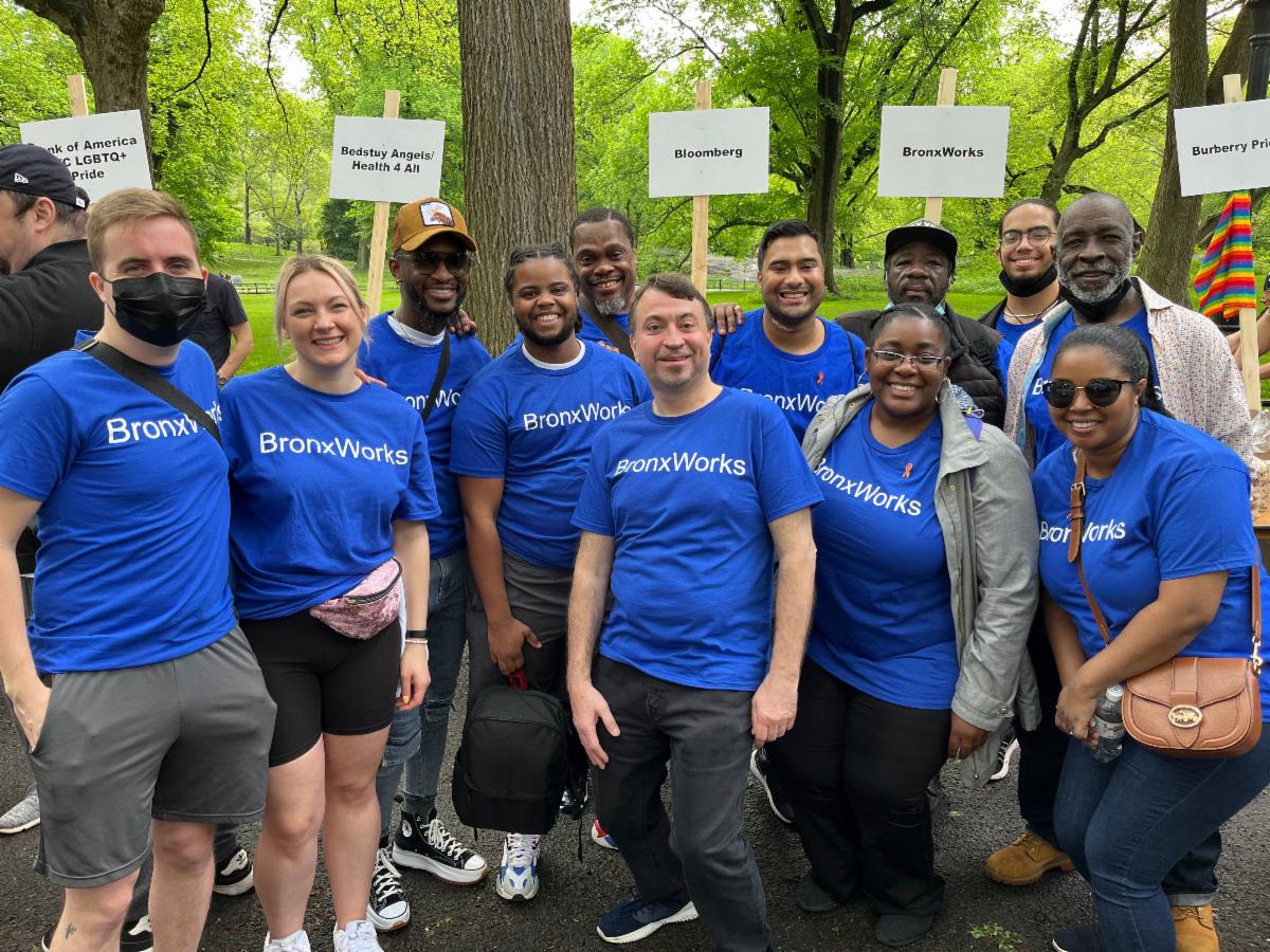 A group of people smiling, wearing blue BronxWorks t-shirts at the AIDS Walk New York 2022