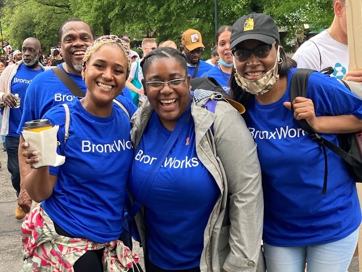 A group of smiling people wearing blue BronxWorks shirts at the AIDS Walk New York 2022.