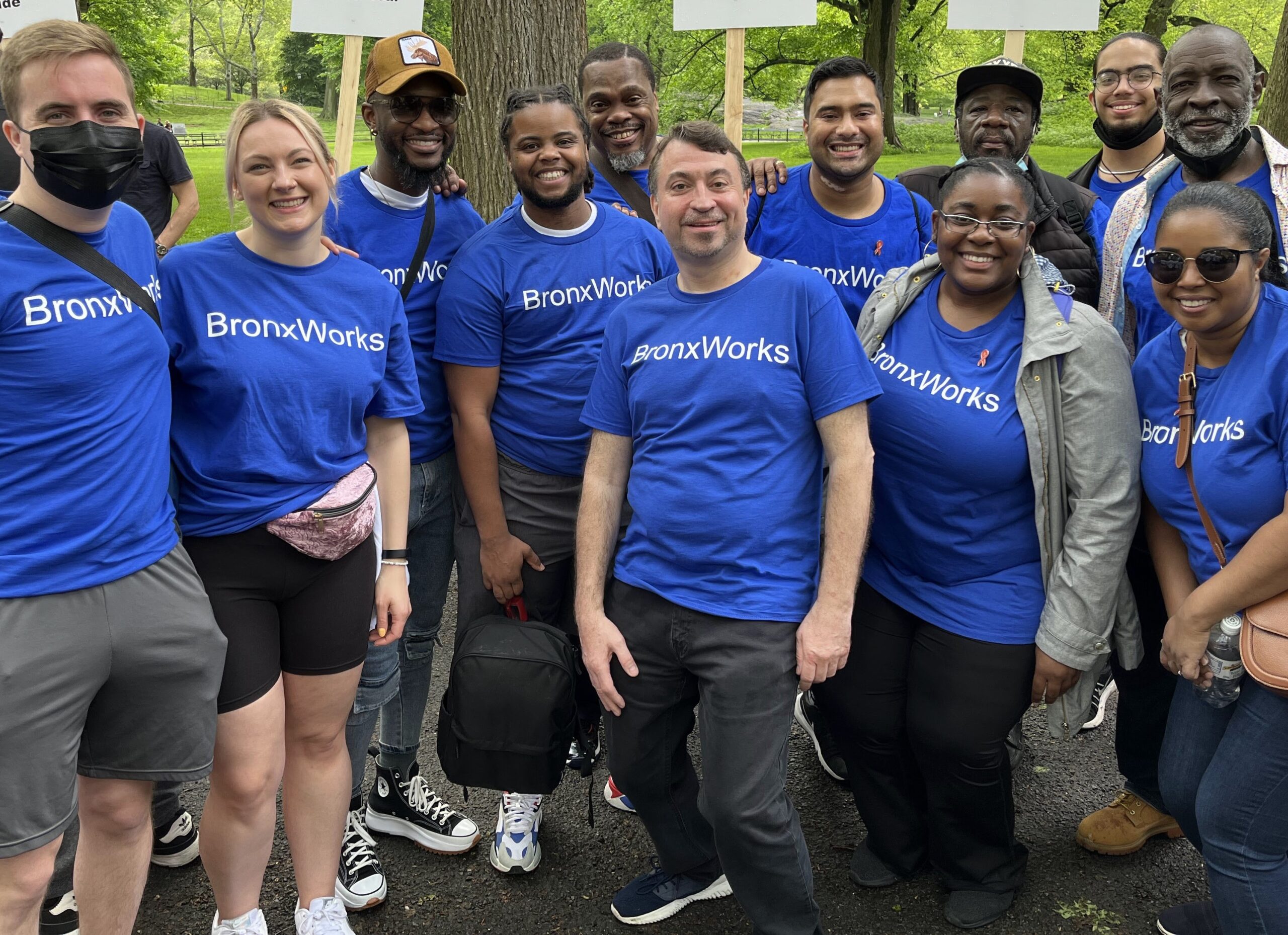 Multiple people stand together wearing BronxWorks shirts