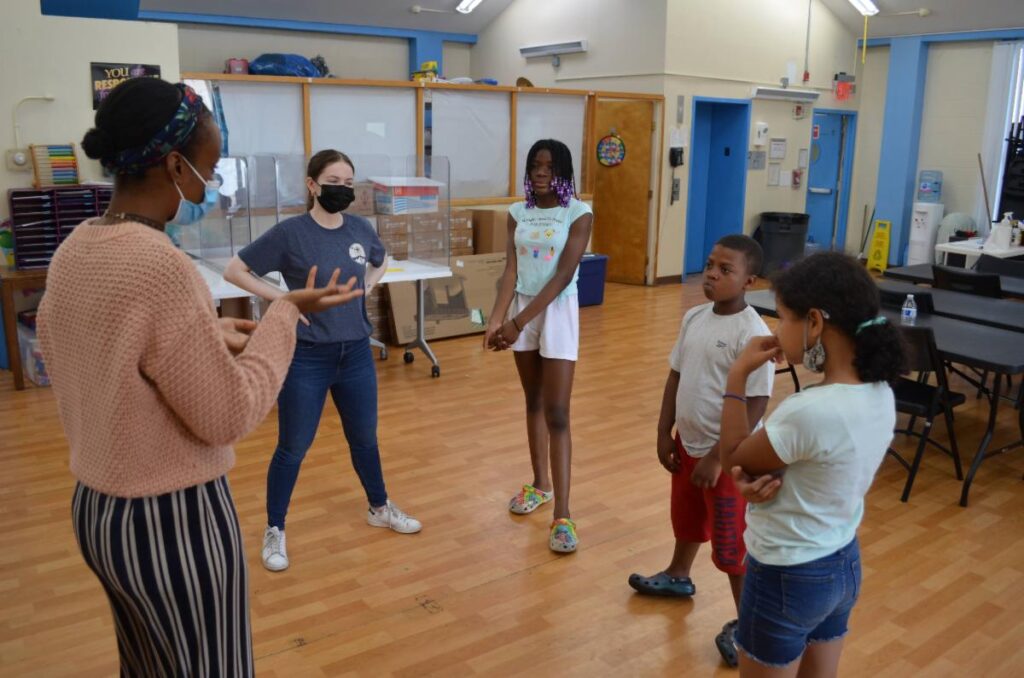 Children at a BronxWorks Family Shelter do some warm-up exercises with teachers from NYC Children's Theater