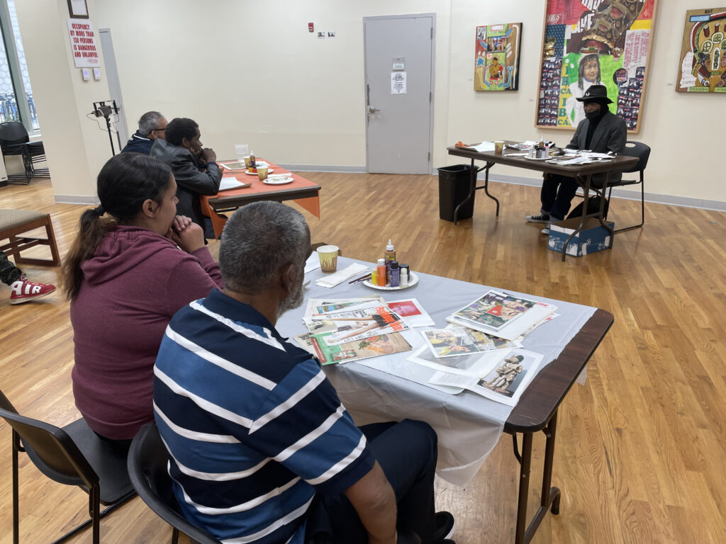 Terrenceo H. teaches a decoupage class to people in attendance at the Boricua College Art Gallery.