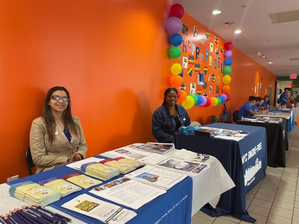 Community partners and BronxWorks programs sit at tables loaded with program information at the BronxWorks Pride Event.