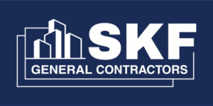 The SKF General Contractors logo. The logo has a blue background. There is a silhouette of a cluster of buildings in the top left, with SKF in white lettering next to it. In smaller white lettering, General Contractors is written.