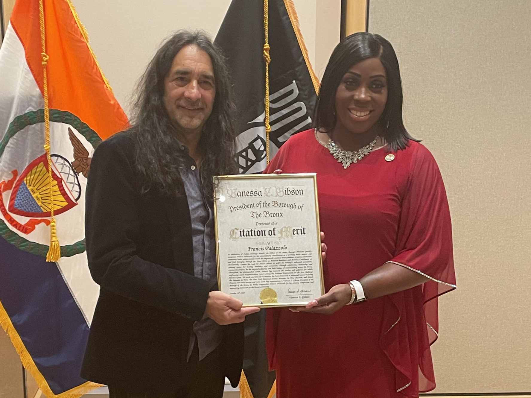 BronxWorks Artist-In-Residence Francis Palazzolo stands with Bronx Borough President Vanessa Gibson. They are holding a citation award.